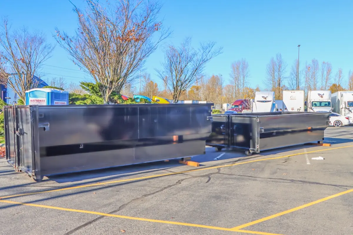 Professional dumpster rental service with roll-off container on residential driveway in Dranesville